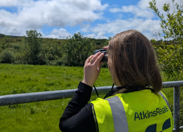 A female employee onsite in her hi viz jacket