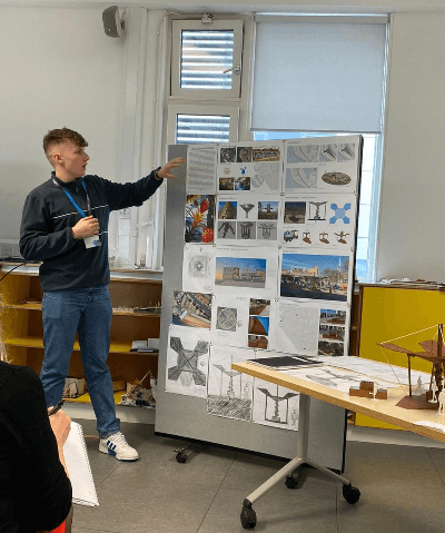 Charlie standing and pointing delivering presentation