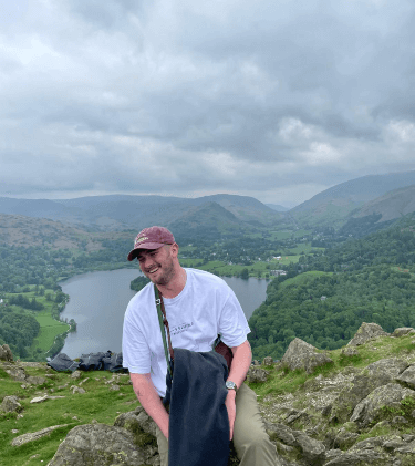 A happy picture of Ben with a beautiful background - lake and mountains