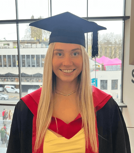 A picture of Alex in her graduation hat and coat