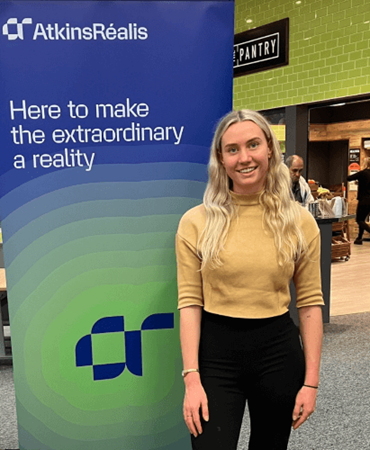 a woman standing near the brochure