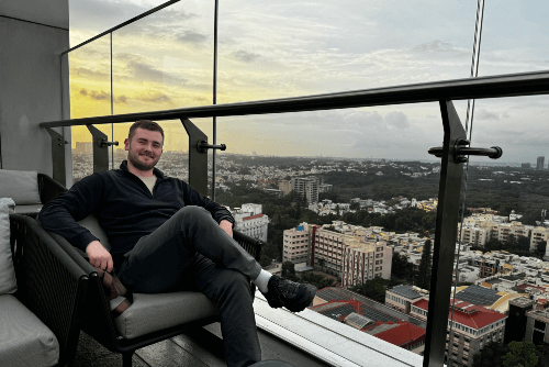 A casual picture of Ben sitting, overlooking a city's view