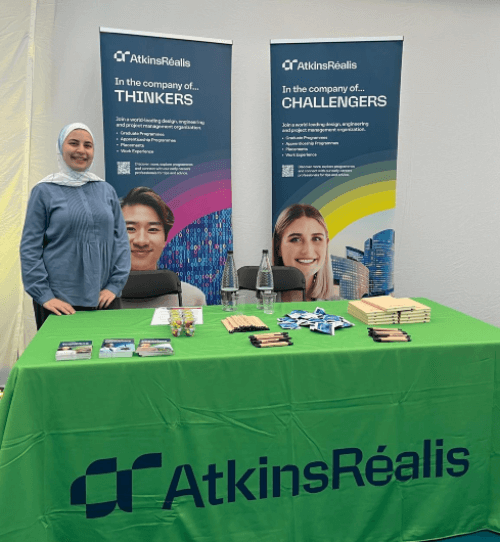A picture of Omaya standing at AtkinsRealis stall at a careers fair